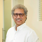 sanjay Office scene with a man in glasses and a white shirt.